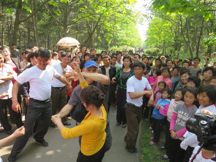 Dancing with the locals in a park in Pyongyang. It was a national holiday (May 1).